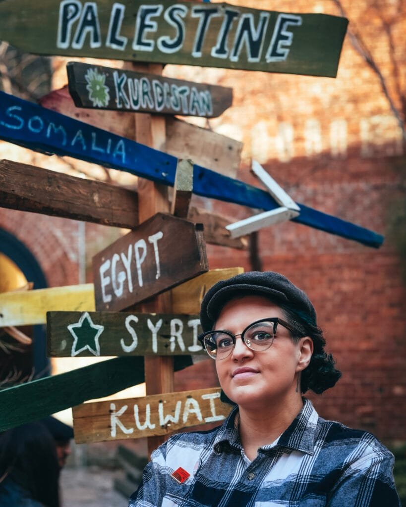jamila hammami in front of signs in dumbo, nyc, image by day1pictures
